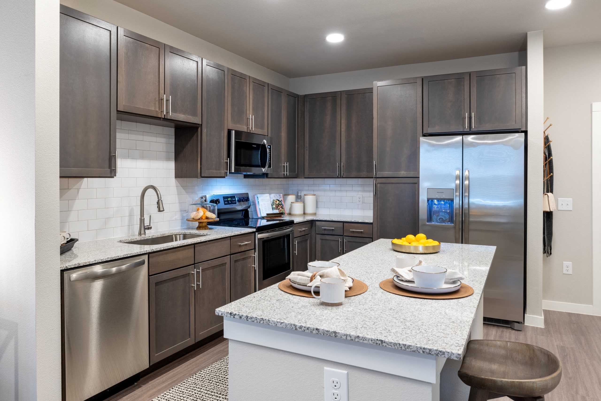 a kitchen with stainless steel appliances and granite counter tops